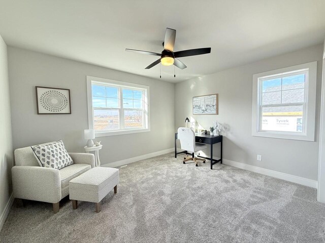 carpeted office space featuring a healthy amount of sunlight, ceiling fan, and baseboards