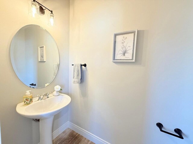 bathroom featuring wood finished floors and baseboards