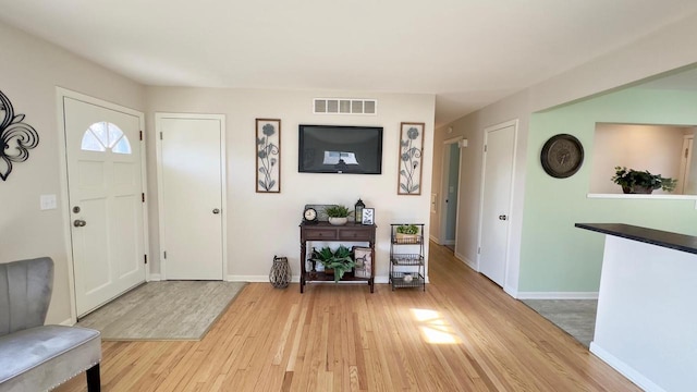 foyer entrance with light wood-type flooring