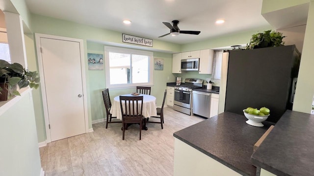 kitchen with light hardwood / wood-style floors, white cabinetry, appliances with stainless steel finishes, and ceiling fan