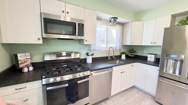 kitchen featuring sink, white cabinets, and appliances with stainless steel finishes