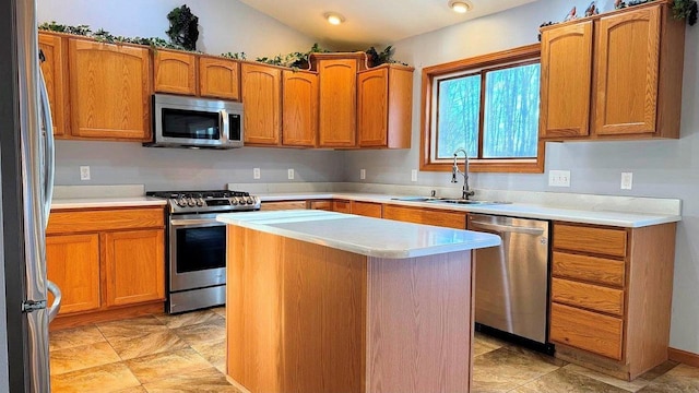 kitchen featuring vaulted ceiling, sink, stainless steel appliances, and a center island