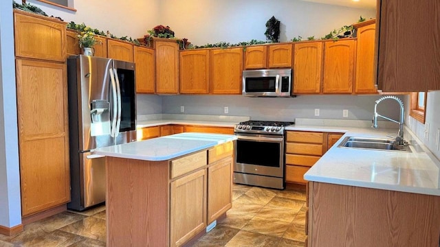 kitchen featuring stainless steel appliances, a kitchen island, and sink