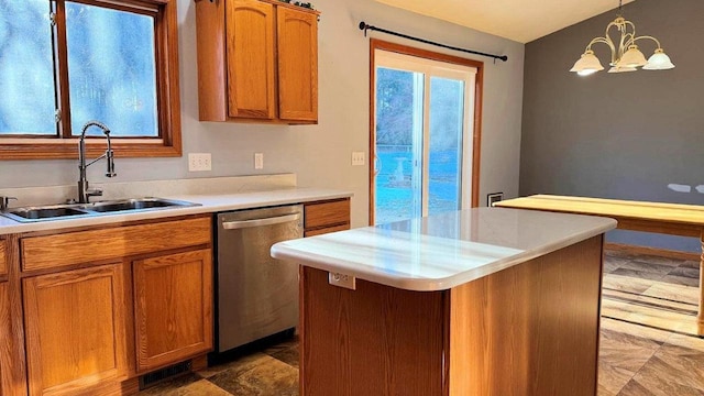 kitchen featuring dishwasher, a kitchen island, sink, hanging light fixtures, and a chandelier