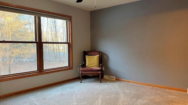 unfurnished room featuring ceiling fan and carpet floors