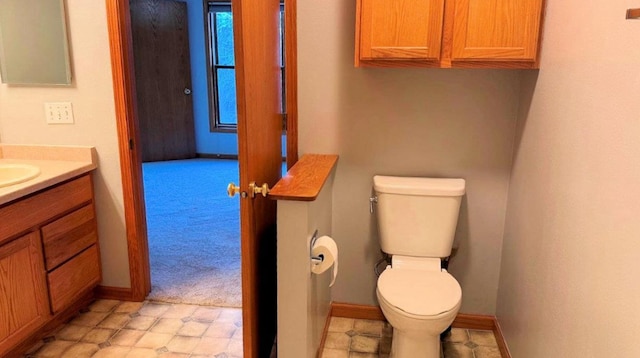 bathroom featuring toilet and vanity