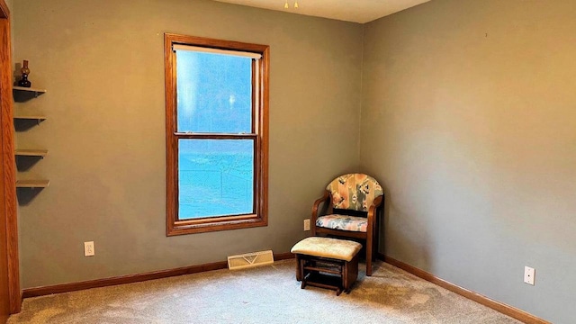 sitting room featuring light colored carpet