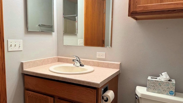 bathroom featuring toilet and vanity