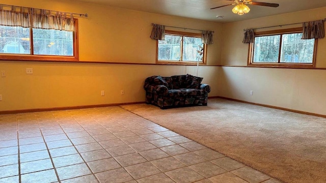 unfurnished room with light carpet, ceiling fan, and plenty of natural light