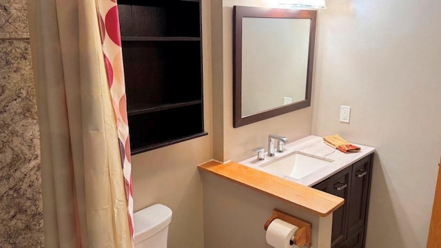 bathroom with toilet and vanity