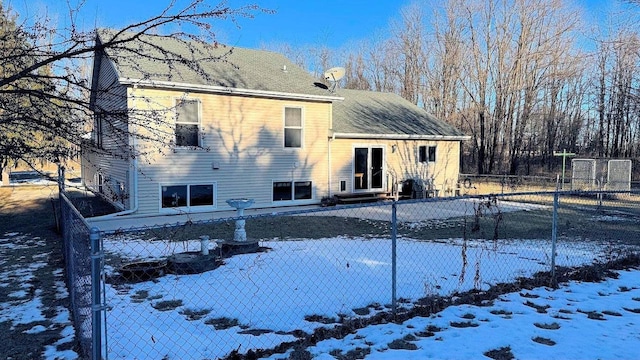 view of snow covered rear of property