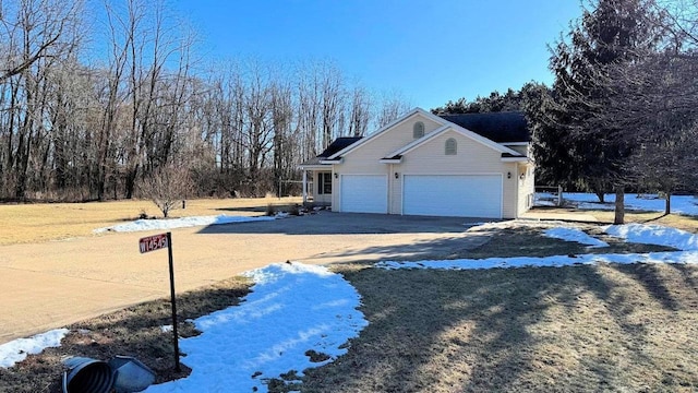 view of snowy exterior with a garage