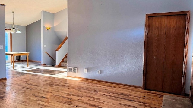 interior space with light hardwood / wood-style floors and a chandelier