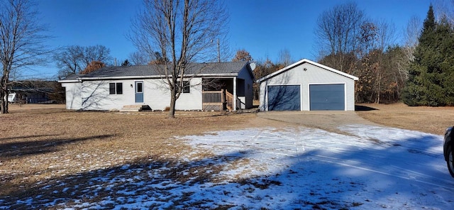 view of front of home with a garage and an outdoor structure