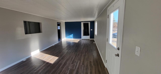 unfurnished room featuring a wealth of natural light and dark hardwood / wood-style flooring