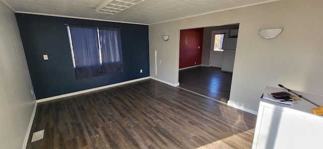 unfurnished room featuring ornamental molding and dark wood-type flooring