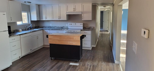 kitchen with sink, dark wood-type flooring, white cabinets, white appliances, and a center island