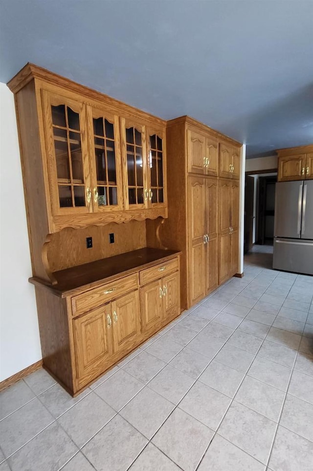 kitchen with stainless steel refrigerator and light tile patterned flooring