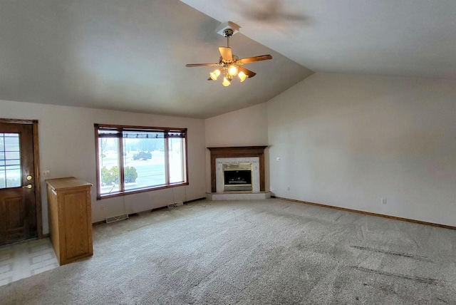 unfurnished living room featuring vaulted ceiling, light colored carpet, and ceiling fan