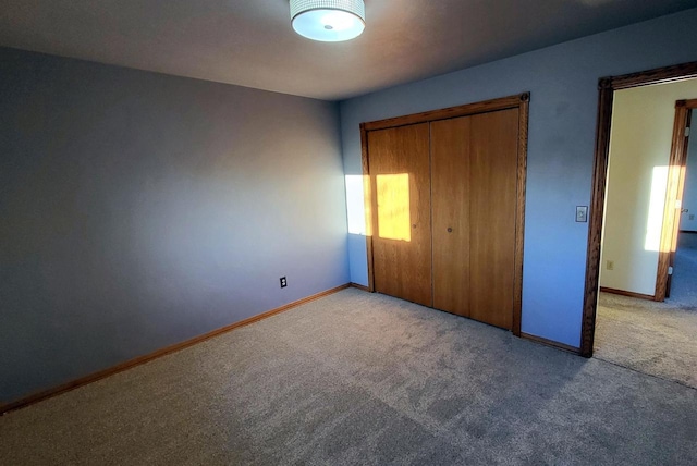 unfurnished bedroom featuring a closet and light carpet