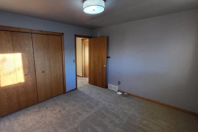 unfurnished bedroom with light carpet and a closet