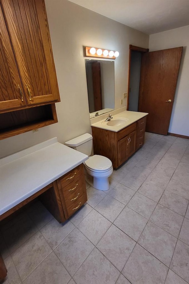 bathroom featuring vanity, toilet, and tile patterned flooring