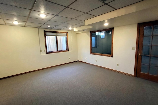 spare room with a paneled ceiling and carpet floors