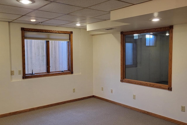 empty room with carpet and a drop ceiling