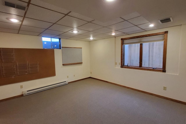 carpeted spare room featuring a baseboard heating unit and a paneled ceiling