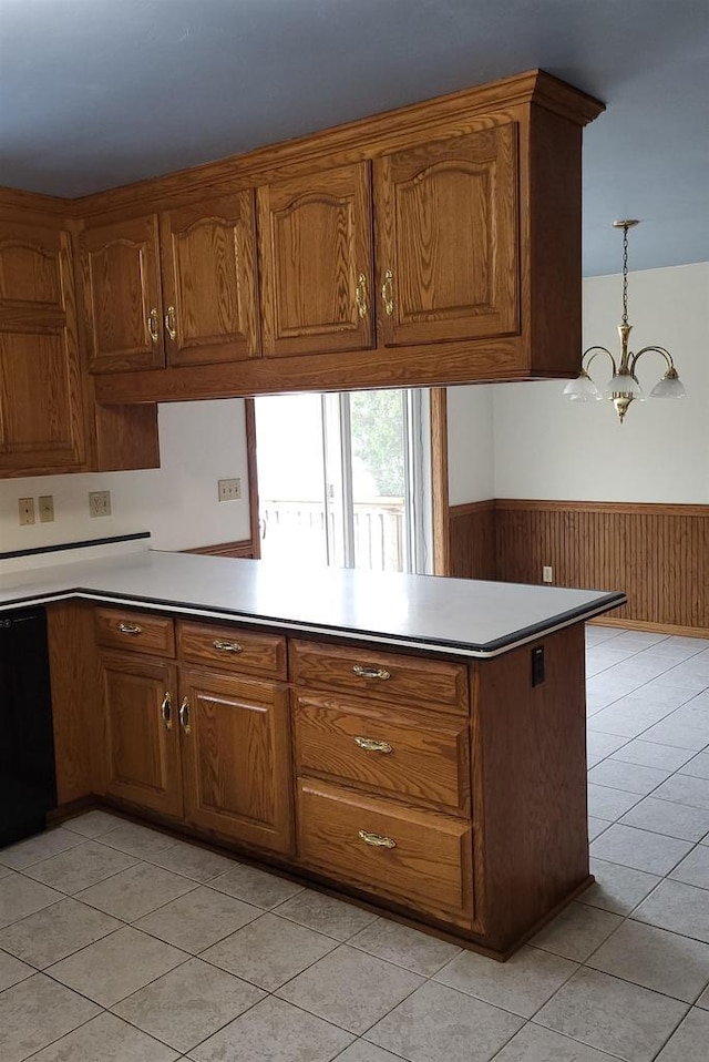 kitchen featuring pendant lighting, light tile patterned flooring, kitchen peninsula, and an inviting chandelier