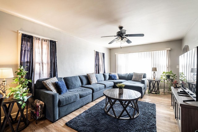 living room featuring light hardwood / wood-style floors, a wealth of natural light, and ceiling fan