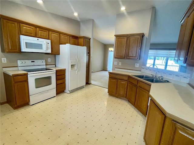 kitchen with vaulted ceiling, sink, and white appliances