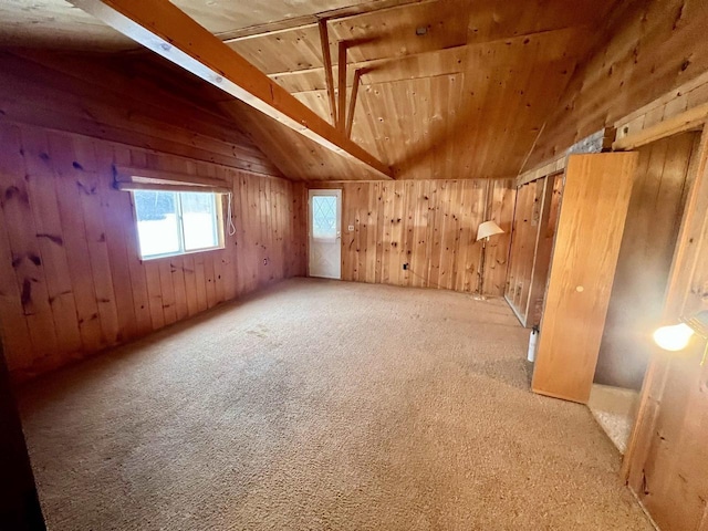 additional living space featuring carpet, vaulted ceiling with beams, wood walls, and wooden ceiling