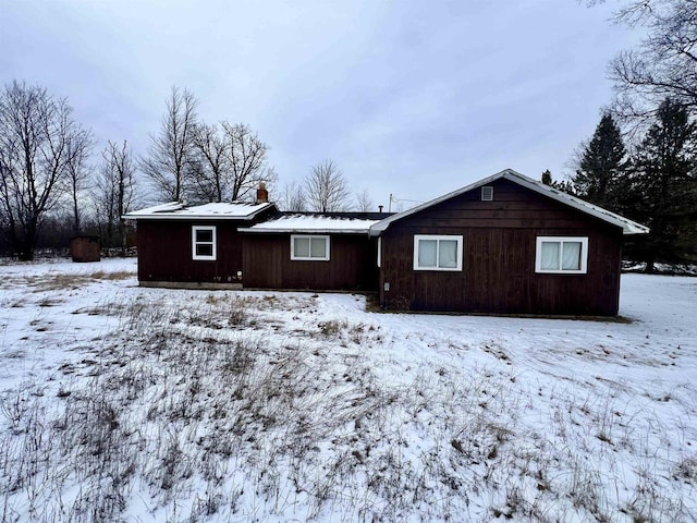 view of snow covered rear of property