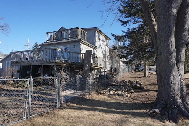 rear view of house featuring a wooden deck