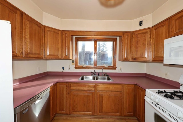 kitchen featuring sink and white appliances