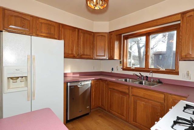 kitchen with dishwasher, white fridge with ice dispenser, sink, and light hardwood / wood-style floors