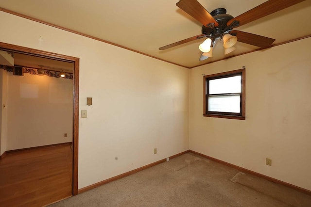 spare room with ornamental molding, light carpet, and ceiling fan