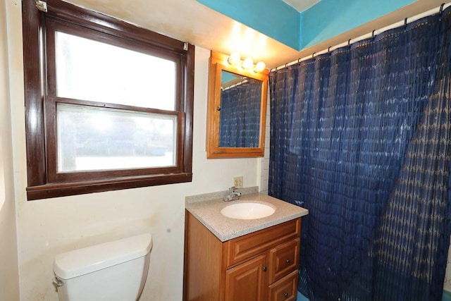 bathroom with vanity, a shower with curtain, and toilet