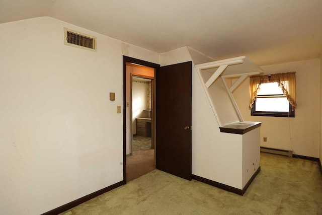 bonus room with lofted ceiling, a baseboard heating unit, and light colored carpet