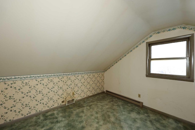 bonus room featuring a baseboard radiator, carpet floors, and vaulted ceiling