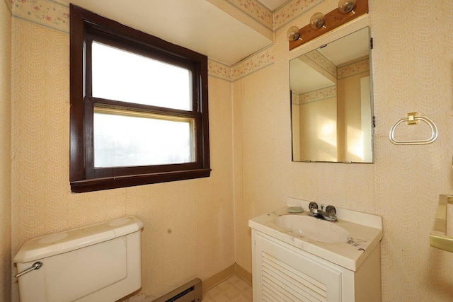 bathroom with vanity, a wealth of natural light, and toilet