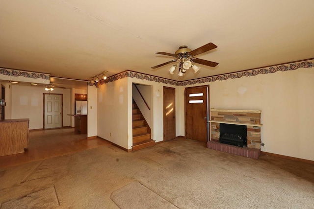 unfurnished living room with ceiling fan and carpet floors