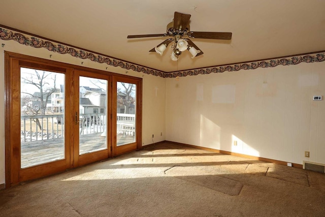 carpeted empty room with ceiling fan and a healthy amount of sunlight