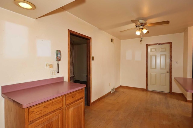 unfurnished room featuring light hardwood / wood-style floors and ceiling fan