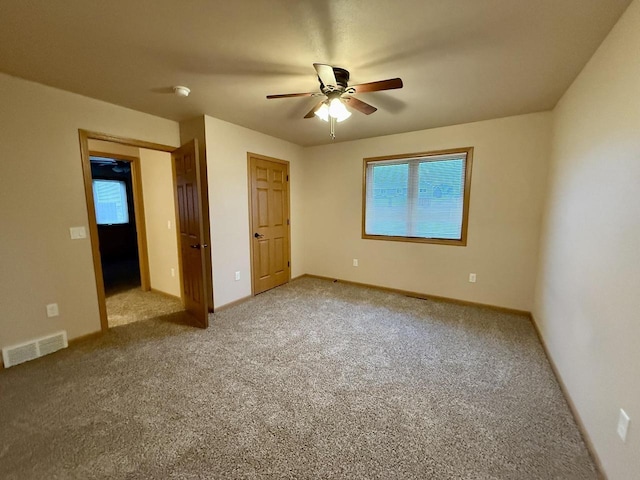 unfurnished bedroom featuring ceiling fan and carpet floors