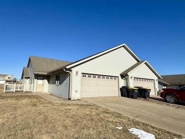 view of front of home with a front lawn and a garage