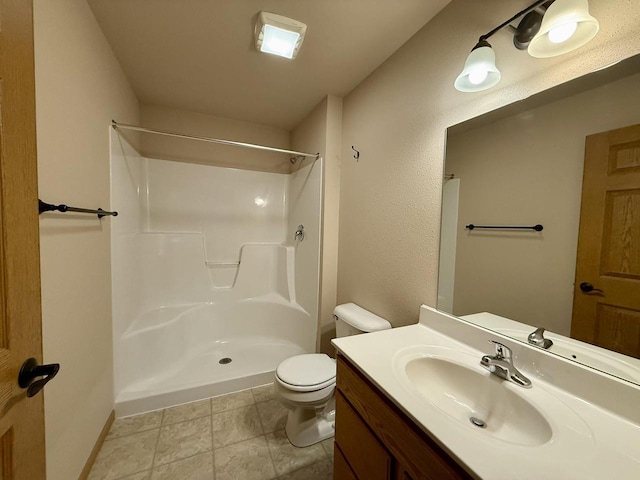 bathroom with toilet, walk in shower, and vanity