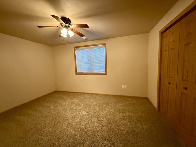 unfurnished bedroom featuring ceiling fan, carpet, and a closet