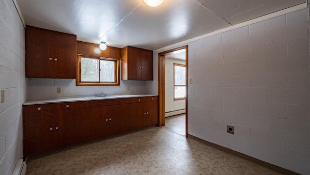 kitchen featuring baseboard heating and sink